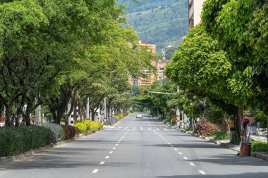 Medellin, Antioquia, Colombia. July 20, 2020: 33rd Avenue. Cityscape of avenue and mountains with sky.