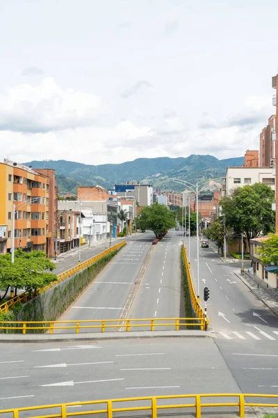 Medellin, Antioquia, Colombia. July 20, 2020: 33rd Avenue. Cityscape of avenue and mountains with sky.