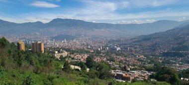 Medellin, Antioquia, Kolombiya. 18 Temmuz 2020: Dağları ve mavi gökyüzüyle Medellin şehrinin panoramik ve kentsel manzarası.
