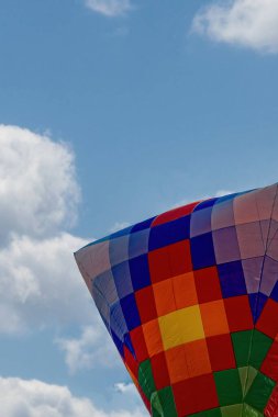 Balloons in the blue sky at the balloon festival in Venice, Antioquia, Colombia.  clipart