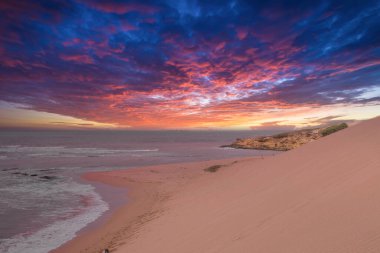 Sunset on the beach in the Taroa desert in La Guajira, Colombia. clipart