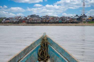 Blue wooden boat and Atrato river in Choco, Colombia. clipart