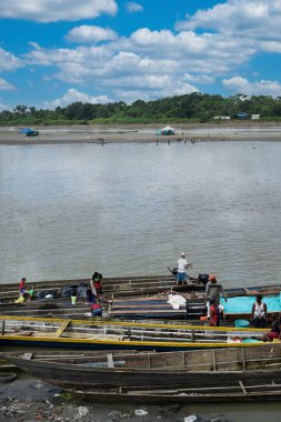 Choc, Quibdo, Colombia. March 4, 2020: Fishermen on the shore of the Atrato river.  clipart