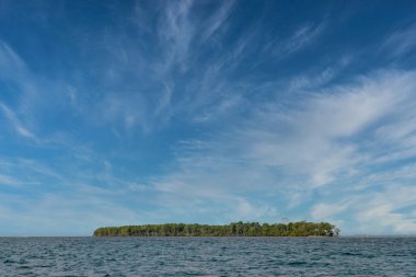 Magle island and caribbean sea landscape with blue sky. San Bernardo, Colombia. clipart