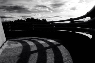 Photos with shadows of a bridge and the sun in black and white. clipart