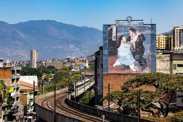 Stock image Medellin, Antioquia, Colombia. January 17, 2024: Painting by Fernando Botero and view of the Medellin metro with blue sky.