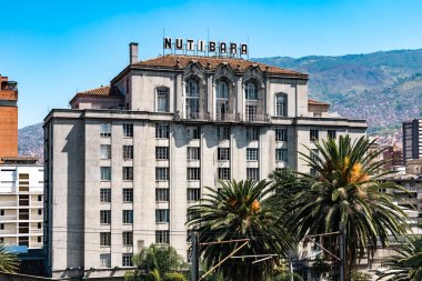 Medellin, Antioquia, Colombia. January 17, 2024: View of the Nutibara hotel and the Medellin metro rails with blue sky. clipart