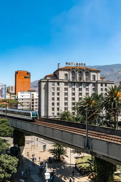 stock image Medellin, Antioquia, Colombia. January 17, 2024: View of the Nutibara hotel and the Medellin metro rails with blue sky.