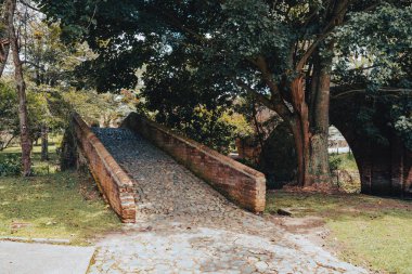 Popayn, Cauca, Colombia. April 30, 2024: View of the Custodia Bridge, also called the Little Bridge, built over the Molino River in 1713 by Don Jacinto de Mosquera y Figueroa. clipart