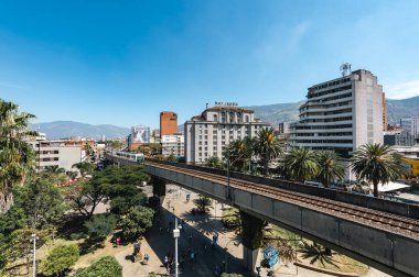 Medellin, Antioquia, Colombia. January 17, 2024: View of the Nutibara hotel and the Medellin metro rails with blue sky. clipart