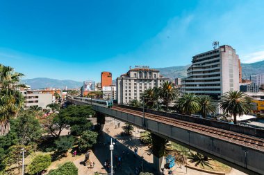 Medellin, Antioquia, Colombia. January 17, 2024: View of the Nutibara hotel and the Medellin metro rails with blue sky. clipart