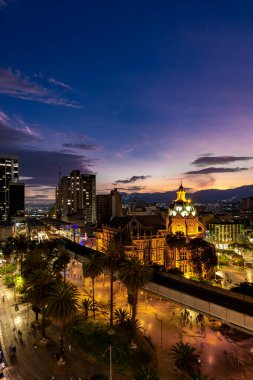 Medellin, Antioquyia, Colombia. January 17, 2024: Rafael Uribe Palace of Culture and metro station with beautiful colorful sunset in the city. clipart