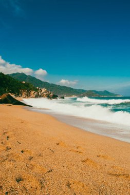 Beautiful landscape with ocean view and blue sky on the beaches of Tayrona Park. Santa Marta, Colombia. clipart