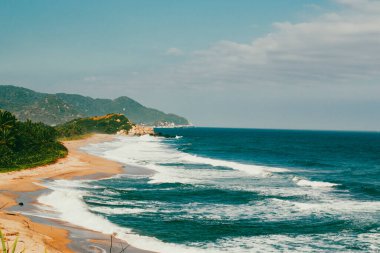 Beautiful landscape with ocean view and blue sky on the beaches of Tayrona Park. Santa Marta, Colombia. clipart