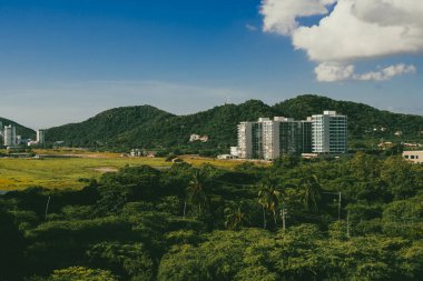 Santa Marta, Magdalena, Colombia. September 19, 2024: red holes in construction sites and blue sky. clipart