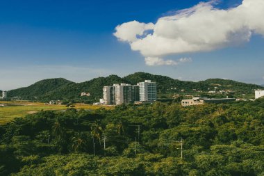 Santa Marta, Magdalena, Colombia. September 19, 2024: red holes in construction sites and blue sky. clipart