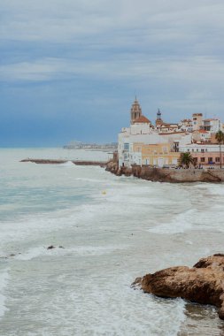 Sitges, Barselona, İspanya. 1 Kasım 2024: San Sebastian sahilindeki eski kasabanın manzarası.