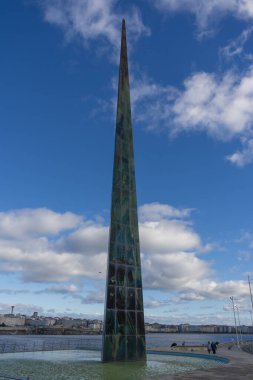 La Coruna, İspanya. 11 Kasım 2024: Milenyum Dikilitaş heykeli ve mavi gökyüzü.