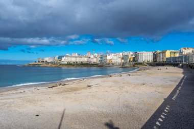 La Coruna, İspanya. 11 Kasım 2024: Orzan sahilinde mavi gökyüzü ve binalar.