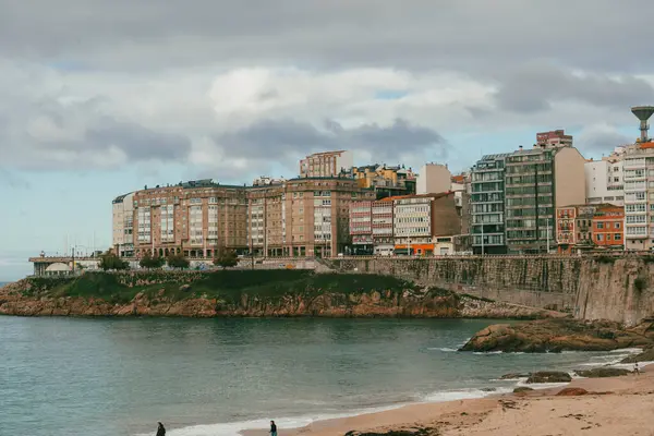 La Coruna, İspanya. 11 Kasım 2024: Orzan sahilinde mavi gökyüzü ve binalar.