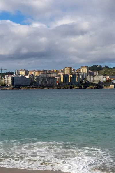 La Coruna, İspanya. 11 Kasım 2024: Orzan sahilinde mavi gökyüzü ve binalar.