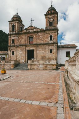 Nemocon, Cundinamarca, Colombia. July 2, 2021: Facade of San Francisco de Ass church and blue sky.