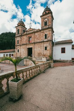 Nemocon, Cundinamarca, Colombia. July 2, 2021: Facade of San Francisco de Ass church and blue sky.