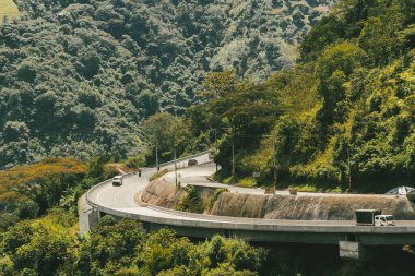 Denize giden yolda dağlar ve mavi gökyüzü olan doğa manzarası. Kolombiya.