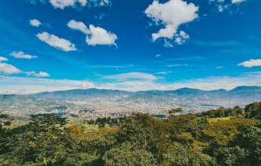 Panoramic landscape of Medellin - Valle de Aburra. Green mountains and beautiful blue sky. Colombia.