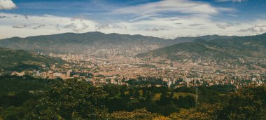 Panoramic landscape of Medellin - Valle de Aburra. Green mountains and beautiful blue sky. Colombia.