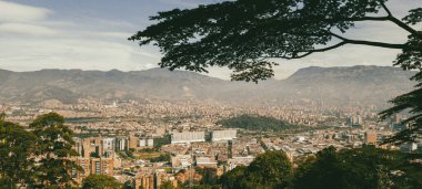 Panoramic landscape of Medellin - Valle de Aburra. Green mountains and beautiful blue sky. Colombia.