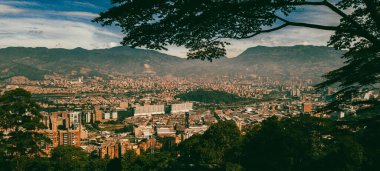 Panoramic landscape of Medellin - Valle de Aburra. Green mountains and beautiful blue sky. Colombia.