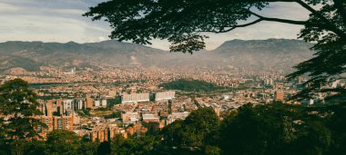Panoramic landscape of Medellin - Valle de Aburra. Green mountains and beautiful blue sky. Colombia.