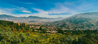 Panoramic landscape of Medellin - Valle de Aburra. Green mountains and beautiful blue sky. Colombia.