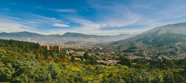 Panoramic landscape of Medellin - Valle de Aburra. Green mountains and beautiful blue sky. Colombia.
