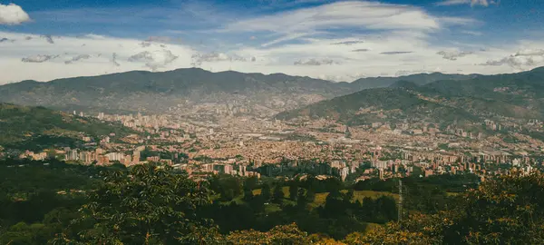 Panoramic landscape of Medellin - Valle de Aburra. Green mountains and beautiful blue sky. Colombia.