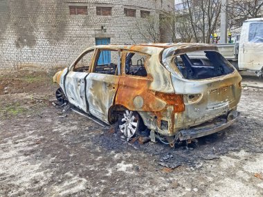 View of burnt car on the street after rocket bomb attack by Russian military. Russian army aviation forces bombed civilian objects. War of Russia against Ukraine. 21.03.22, Kharkiv, Ukraine