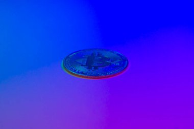 Bitcoin coin on blue circuit background. Cryptocurrency, virtual money. Blockchain technology, bitcoin mining concept. In blue-pink colored background