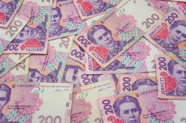 Ukrainian money background. banknotes with a face value of 200 hryvnia money background. Ukrainian money. Business concept. Background with hryvnia. Pink-blue