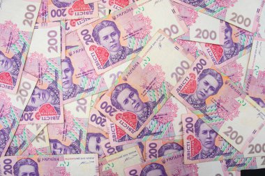 Ukrainian money background. banknotes with a face value of 200 hryvnia money background. Ukrainian money. Business concept. Background with hryvnia. Pink-blue