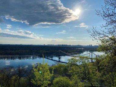 Beautiful view of suspension bridge over river on sunny day. view of the suspension bridge kyiv