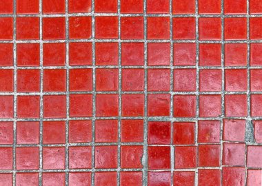 Texture of fine ceramic tiles close up. Texture of fine little ceramic tiles background. Mosaic-coated surface with fine square tiles. Red floor tiles