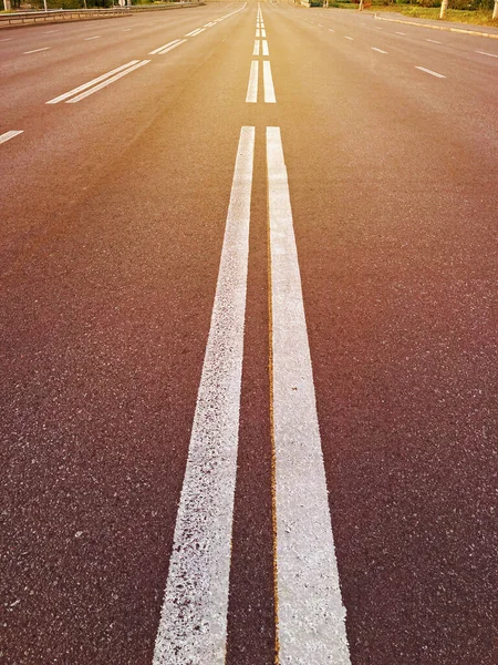 stock image Double white lines on the asphalt road in the middle. double broken line on the road