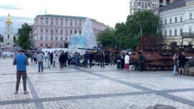 Ukraynalılar Mikhailovskaya Meydanı 'ndaki Rus askeri teçhizatının kalıntılarını hava saldırısı alarmlarının seslerini bulmak için araştırıyorlar. Kyiv, Ukrayna - 23.03.2023