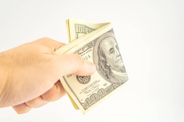 El ele tutuşan para beyaz arka planda izole. Ödeme ve verme için 100 dolarlık banknot. İş ve Finans konsepti. 100 dolar nakit para. Paralı eller Amerikan doları.