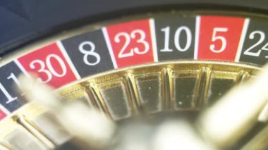 Dönen ruleti yakından çek. Sarı dönen bir alev topuyla lüks bir kumarhane ruleti sunumu. Las Vegas Kumarhanesi 'nde altın elementlerle cilalanmış, zarif bir rulet. Şanslı oyun