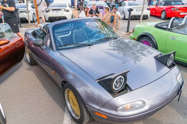 The image appears to be a composite of two different photographs On the left side, there is a scene showing a sports car parked on what looks like a Kyiv, Ukraine 06-06-2024 clipart