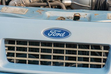 A Ford vehicles front grille section is depicted with visible rectangular openings featuring horizontal bars, accompanied by a logo reading Ford on Kyiv, Ukraine 06-06-2024 clipart