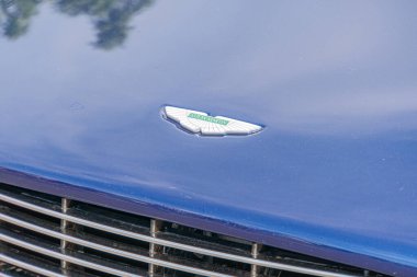 A blue car has its grille in focus, with part of the hood visible in front The vehicles bodywork appears clean and well-maintained A stylized winge Kyiv, Ukraine 06-06-2024 clipart