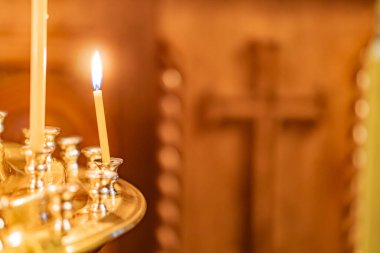 Image depicts a group of candles in a religious or ceremonial setting, with two blue-flamed candles as the main focus Other candles surround them, creating an impression of a larger ceremony clipart